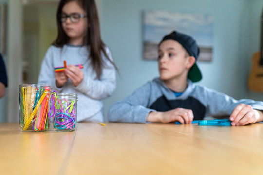Children building catapults with popsicle sticks and rubberbands as part of a homeschool STEM lesson