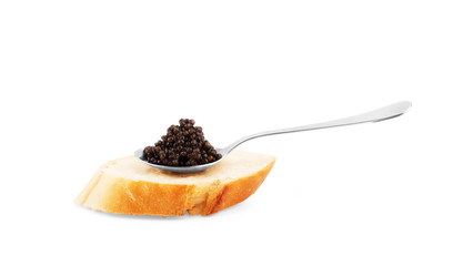 Metal spoon with black caviar on white background