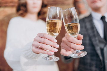 the bride and groom are holding glasses of champagne
