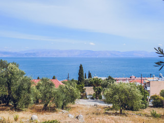 Fototapeta premium Greece, Corfu island. A beach with crystal clear azure water and a white beach in picturesque landscapes - the paradise coastline of the island of Corfu in Paleokastritsa, Ionian archipelago