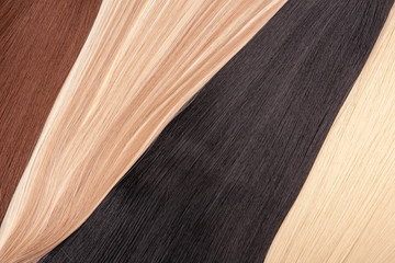 Long hair extensions in natural colors. Black, brown, blonde, and blonde balayage.