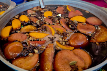 Mulled wine in a large cauldron. Vitamins in the winter festival.