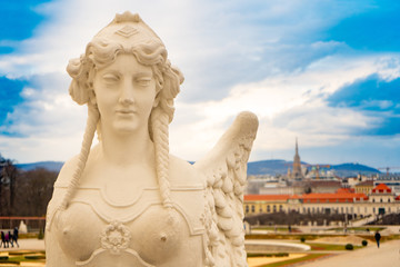 Fototapeta na wymiar Old sculpture with Vienna city view in Belvedere park. Austria. Wien. Europe