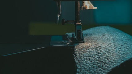 A Sewing Machine Sews Burlap Fabric. Sewing Hemp Fabric Clothing. Close-Up Macro Shot. Sewing Still Life. High Quality Photo
