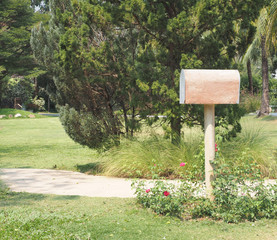 Mail box or post box in the flower garden or front of house.