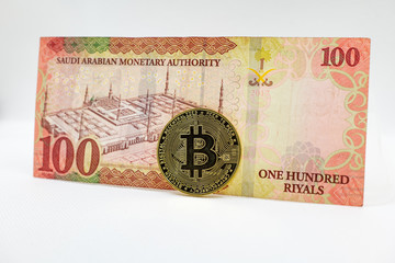 Saudi Arabian 100 Riyal bank note with Bitcoin crypto currency