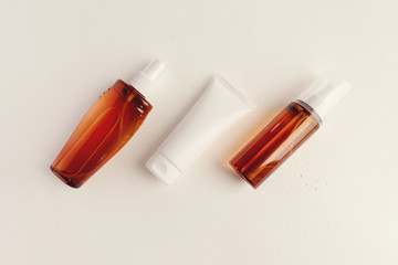 Summer sunscreen. Set of cosmetic bottles on a light background. Place for text. Copyspase.