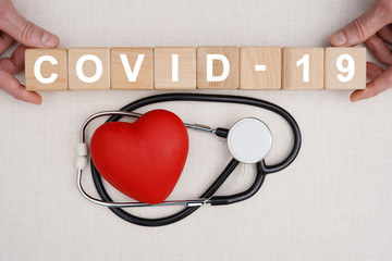 Doctor hand arranging wood block stacking with text covid-19 virus, coronavirus healthcare,...