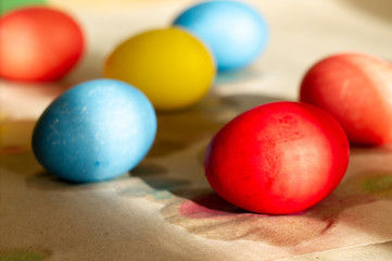 Obraz na płótnie Canvas Set of homemade colorful Easter eggs on parchment paper. Spring holiday symbols. Christian gift.