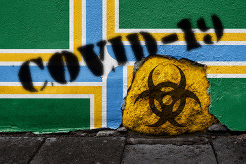Flag of the city of Portland on the wall with covid-19 quarantine symbol on it. 2019 - 2020 Novel Coronavirus (2019-nCoV) concept, for an outbreak occurs in Portland, Oregon, US.