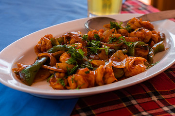 Indian chinese Prawn/Shrimp chilly fry plated and served on a table