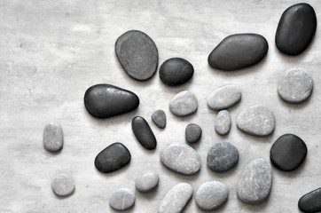 Flat lay composition with spa stones on grey background.