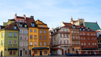 Fototapeta premium Warsaw, Poland - 18/ 03/ 2020:. Beautiful multi-colored houses in the old town in Warsaw. The central streets of the historic center of Warsaw. The main tourist attraction of Warsaw. 