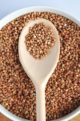 buckwheat on a plate and spoon isolated background