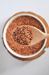 buckwheat on a plate and spoon isolated background