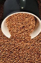 buckwheat on a plate and spoon isolated background