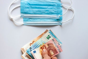 medical masks and euro banknotes deficit concept