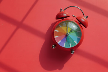 red color alarm clock on red background, top view.