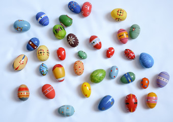 Fototapeta na wymiar multicolored wooden eggs on white background