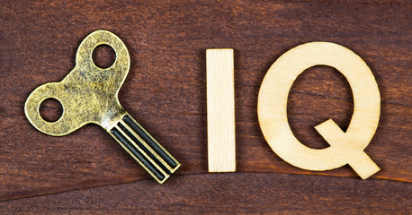 Intelligence quotient, iq test, brain concept, key with letters on a brown wooden background, web...