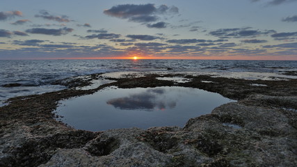 sunset by the beach rocks