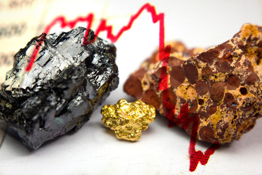 Red stock market trendline and close-up of Bauxite (Aluminium ore), coal and a gold nugget