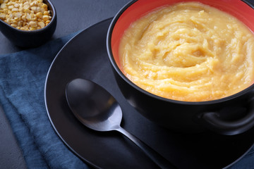 Yellow pea puree in a bowl. Horizontal composition