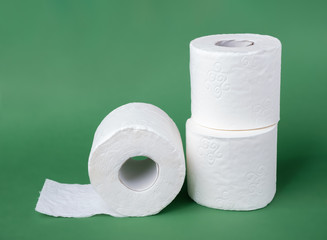 Toilet paper rolls on a green background. Scarce commodity in a time of crisis