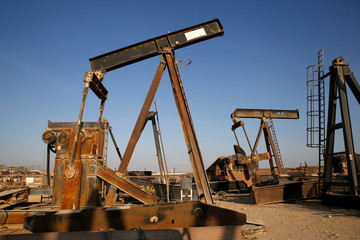Fototapeta na wymiar Old oil pump jacks at a scrap yard, Oman