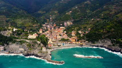 Obraz premium Monterosso is a village in the province of La Spezia, which is part of the Liguria region (northern Italy). It is one of the five Cinque Terre villages. aerial view with a drone and travel concept 