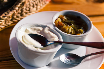 Ukraine fried fat and onion with sour cream in restaunrant in Lviv. Close up shoot of food. Traditional meal in restaurant. Rustic eating. Yellow and white colors. National dish. Nobody. Indoor.