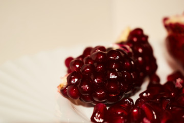 Berries of red pomegranate. Scattered on a white background