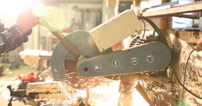 Bladesmith sawing metal with hacksaw