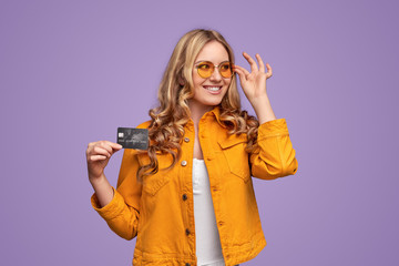 Cheerful young woman with credit card