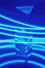 Glass Prism with reflection on a abstract blue neon background