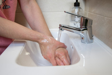 Woman washing her hands.