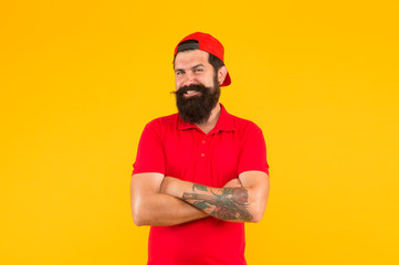 Confident and stylish. Happy hipster yellow background. Bearded man in trendy hipster style. Hipster lifestyle. Cool hipster with beard wear baseball cap. Fashion and style. Barbershop. Beard barber