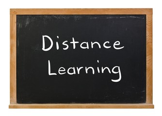 Distance learning written in white chalk on a black chalkboard isolated on white
