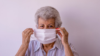Elderly woman wearing protective mask against corona virus