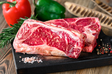 Raw beef steaks with seasonings