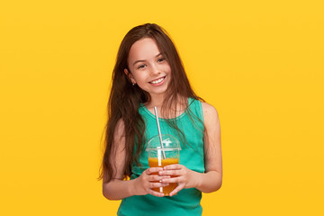 Cheerful teen girl with fresh beverage