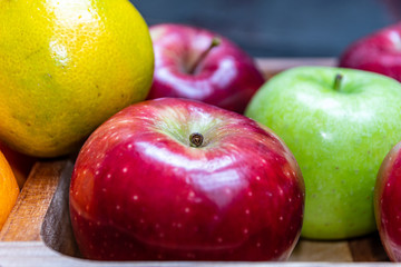 red and green apples oranges and tasty tangerines along with other fruits