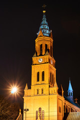 belfry of neo-Gothic brick Catholic church at night in Poznan.