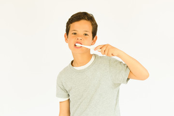 Young beautiful boy is brushing teeth