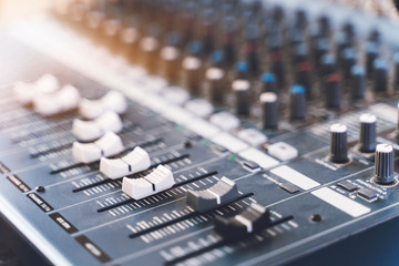 Sound mixer. Professional audio mixing console with lights, buttons, faders and sliders.
