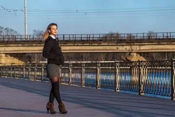 Beautiful Young Woman Walking On Embankment at Sunny Day.