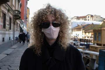 Milan, Italy, Lombardy - 25 February 2020: people in face masks to protect themselves from the corona virus epidemic on the streets of Milan