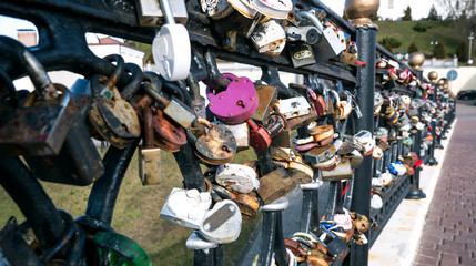 Symbolic love padlocks fixed to the railings of the bridge.
