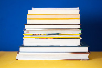 Group of books on a blue background. Concept: reading, literature and education