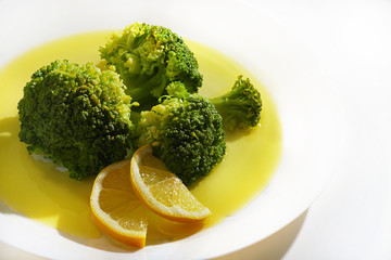 Cooked broccoli on white plate